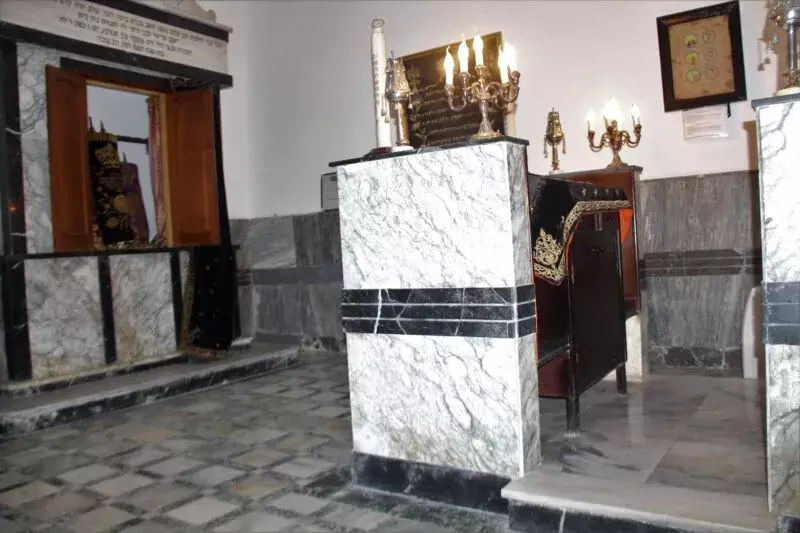 Vue sur l'arche de la Torah et la Tébah en marbre blanc veiné ornées de candélabres au sein de la synagogue Rebbi Yosef Laredo, dite de Rebbi Aquiba, un site restauré du réseau des synagogues et musées juifs de la médina de Tanger