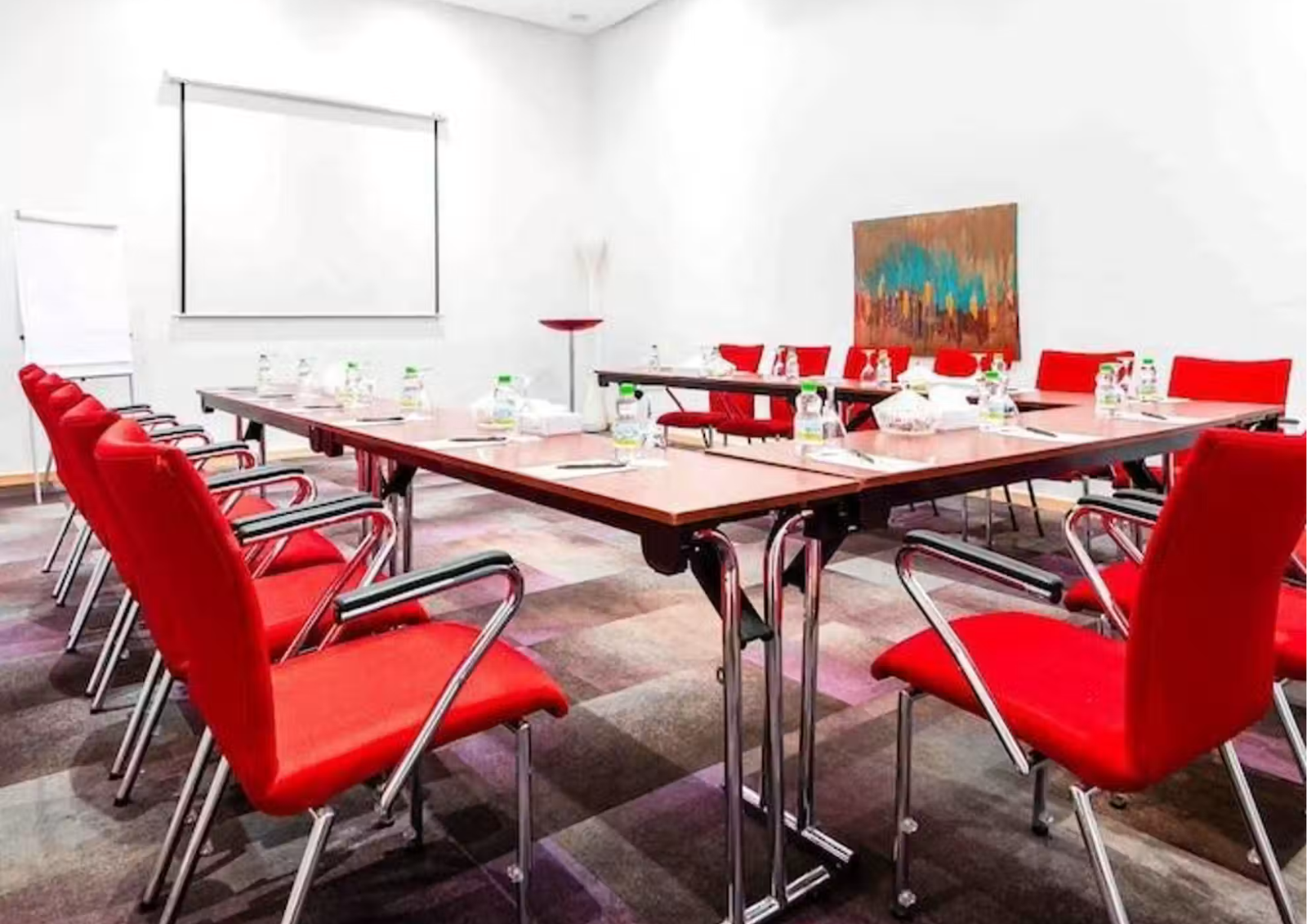 Une salle de sous-commission du Farah Tanger aménagée avec des chaises rouges en configuration style U.